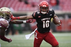 Oct 24, 2020; Louisville, Kentucky, USA;  Louisville Cardinals running back Javian Hawkins (10) runs the ball against Florida State Seminoles defensive back Raymond Woodie III (31) during the first half of play at Cardinal Stadium. Jamie Rhodes-ACC Pool