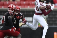 Oct 24, 2020; Louisville, Kentucky, USA;  Florida State Seminoles wide receiver Ontaria Wilson (80) catches a pass under the pressure of Louisville Cardinals defensive back Chandler Jones (2) during the first half of play at Cardinal Stadium. Jamie Rhodes-ACC Pool