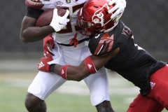 Oct 24, 2020; Louisville, Kentucky, USA;  Louisville Cardinals defensive back Russ Yeast (3) makes an open field tackle against Florida State Seminoles wide receiver Jordan Young (83) during the first half at Cardinal Stadium. Jamie Rhodes-ACC Pool