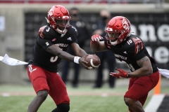 Oct 24, 2020; Louisville, Kentucky, USA;  Louisville Cardinals quarterback Malik Cunningham (3) hands the ball off to running back Javian Hawkins (10) during the first half at Cardinal Stadium. Jamie Rhodes-ACC Pool