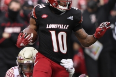 Oct 24, 2020; Louisville, Kentucky, USA;  Louisville Cardinals running back Javian Hawkins (10) slips a Florida State Seminoles defensive back Jaiden Lars-Woodbey (6) tackle during the second half of play at Cardinal Stadium. Jamie Rhodes-ACC Pool